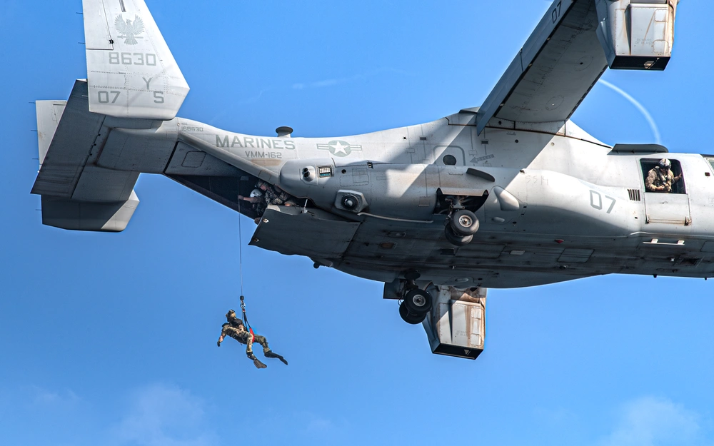 A U.S. Air Force pararescueman assigned to the 82nd Expeditionary Rescue Squadron (ERQS) repels down from a MV-22 Osprey to recover personnel in the water during exercise Bull Shark in Djibouti on November 26, 2024.