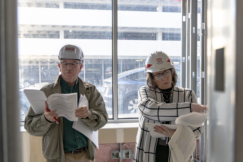  Kathy Cherrito (right) Real Estate Specialist for the U.S. Army Corps of Engineers Kansas City District, going over contract details during a site visit in the buildout phase of a new United States Navy Recruiting Office on Monday, April 7.