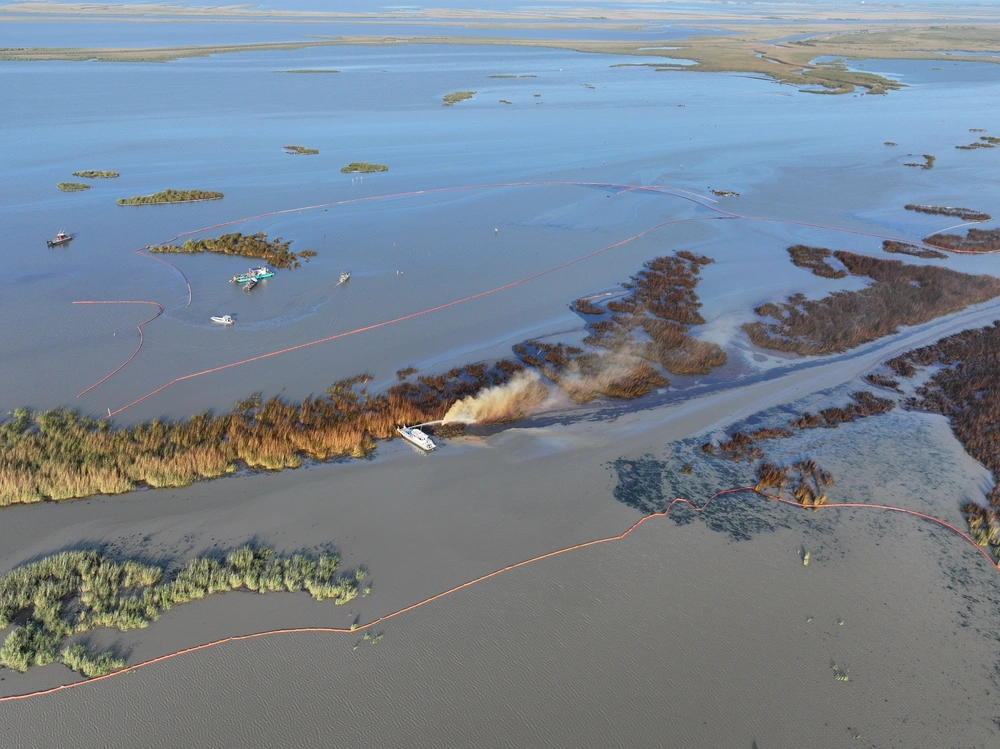 An overflight displays the affected area of marsh environment near Garden Island Bay, Louisiana on May 1, 2025. A safety zone has been enacted in the area and boom has been placed to contain the released product. (U.S. Coast Guard courtesy photo) An overflight displays the affected area of marsh environment near Garden Island Bay, Louisiana on May 1, 2025. A safety zone has been enacted in the area and boom has been placed to contain the released product. (U.S. Coast Guard courtesy photo)