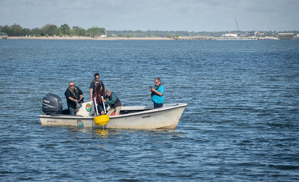 Tactical Integrated Data Ecosystem (TIDE) yellow and white buoy floating in the water