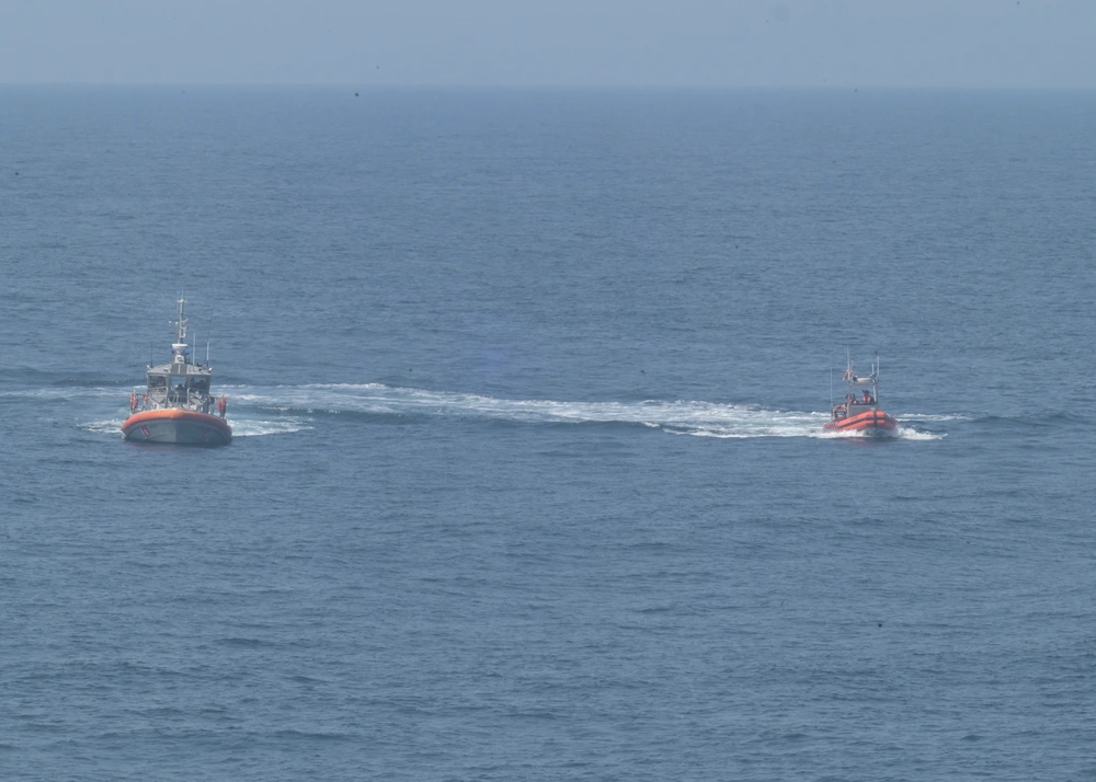 Two men are rescued by the crew of the USCGC Calhoun (WMSL 759) and Coast Guard Station Little Creek, June 12, 2025 from a life raft after their 57-foot sport fisher vessel, Turn Me Loose, sank 34 miles southeast of Virginia Beach, Virginia. 