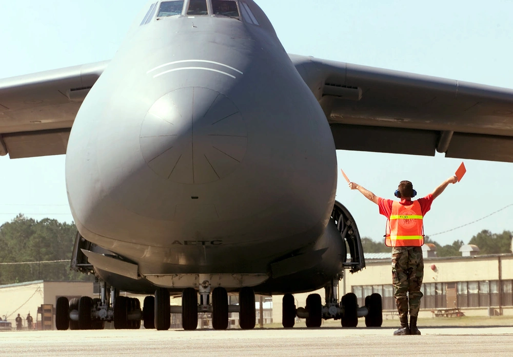 DVIDS - Images - A C-5 Galaxy is directed to a parking spot on the ramp ...