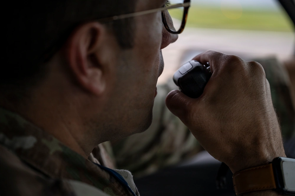 Airfield team member using a handheld radio