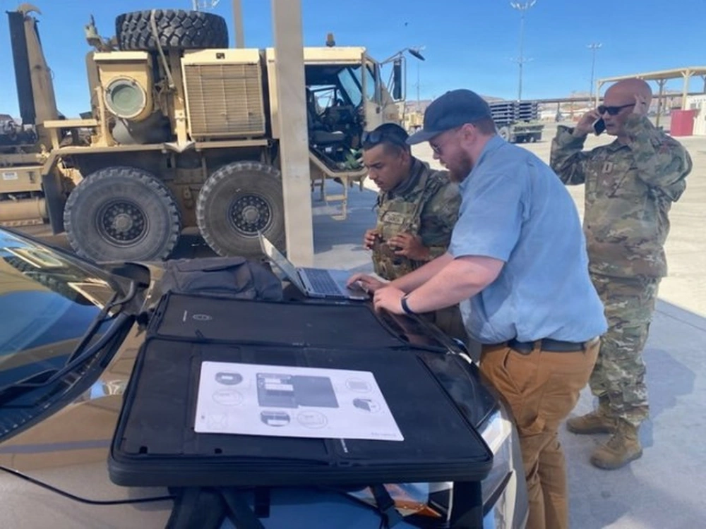 AI tools are becoming critical to modern warfare. In this photo, Sean Murphy works alongside Soldiers on the artificial intelligence assisted maintenance (AIAM) tool during a test at the National Training Center on Fort Irwin, California.