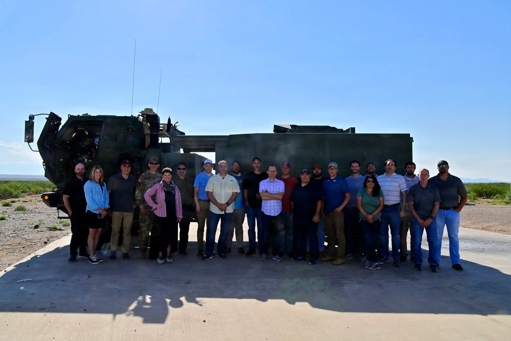 Blenk with the Assured Precision Weapons and Munitions Alternate-Navigation team at a Precision Guided Munition Alternative Navigation live-fire demonstration at White Sands Missile Range, New Mexico on June 29, 2022, after successfully guiding a missile to a target using low earth orbit satellites in lieu of GPS.