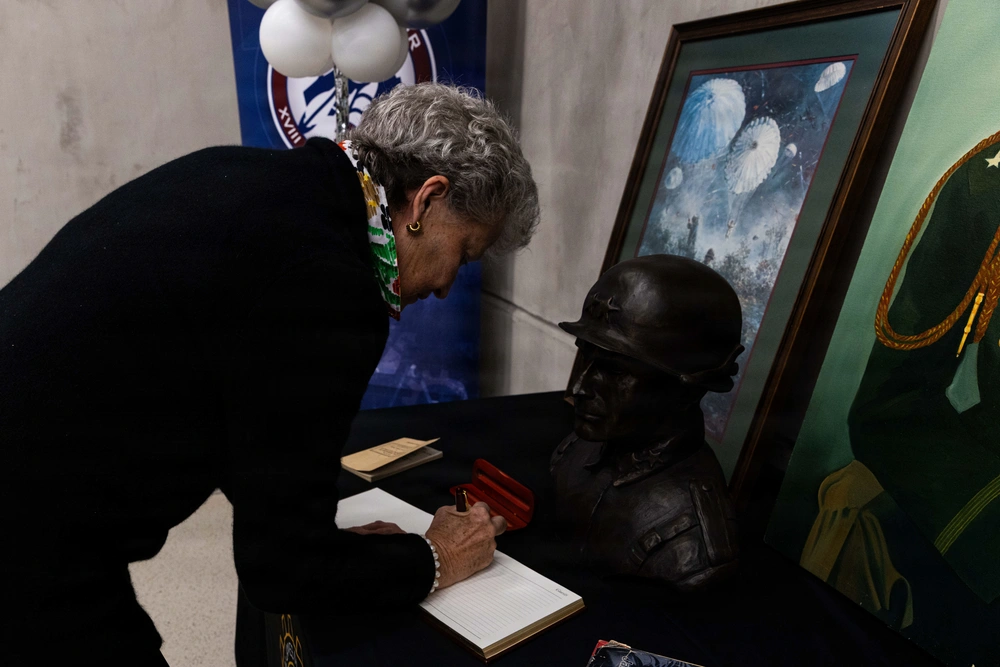 Chloe Gavin, Lt. Gen. James M. Gavin’s daughter, commemorates the opening of the Joint Innovation Outpost dedicated to her father by being the first person to sign the visitor’s log on Fort Bragg, North Carolina, Jan. 23, 2026. The outpost is equipped with cutting-edge resources designed to foster creativity and solve problems in real time.
