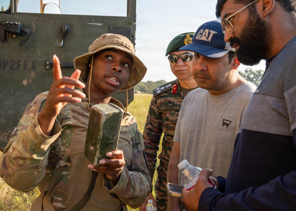 Spc. Lameka Byrd, 36th Engineer Brigade, explains the functionality of a terrain-shaping munition to a group of observers during a field demonstration.