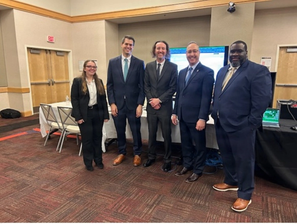 Personnel from the U.S. Army Audit Agency and CECOM ASIC presented interactive demonstrations of Army $pends at the Army Data Tech Demo in Washington, March 17-19, 2026. From left are Mary Moor, AI engineer, CECOM ASIC; Benjamin Tillman, branch chief, CECOM ASIC; Scott Anderson, senior data engineer, U.S. Army Audit Agency (USAAA); Bill Gable, acting deputy auditor general for Financial Management Audits, USAAA; and Jason Branch, chief, Data Analytics, USAAA.